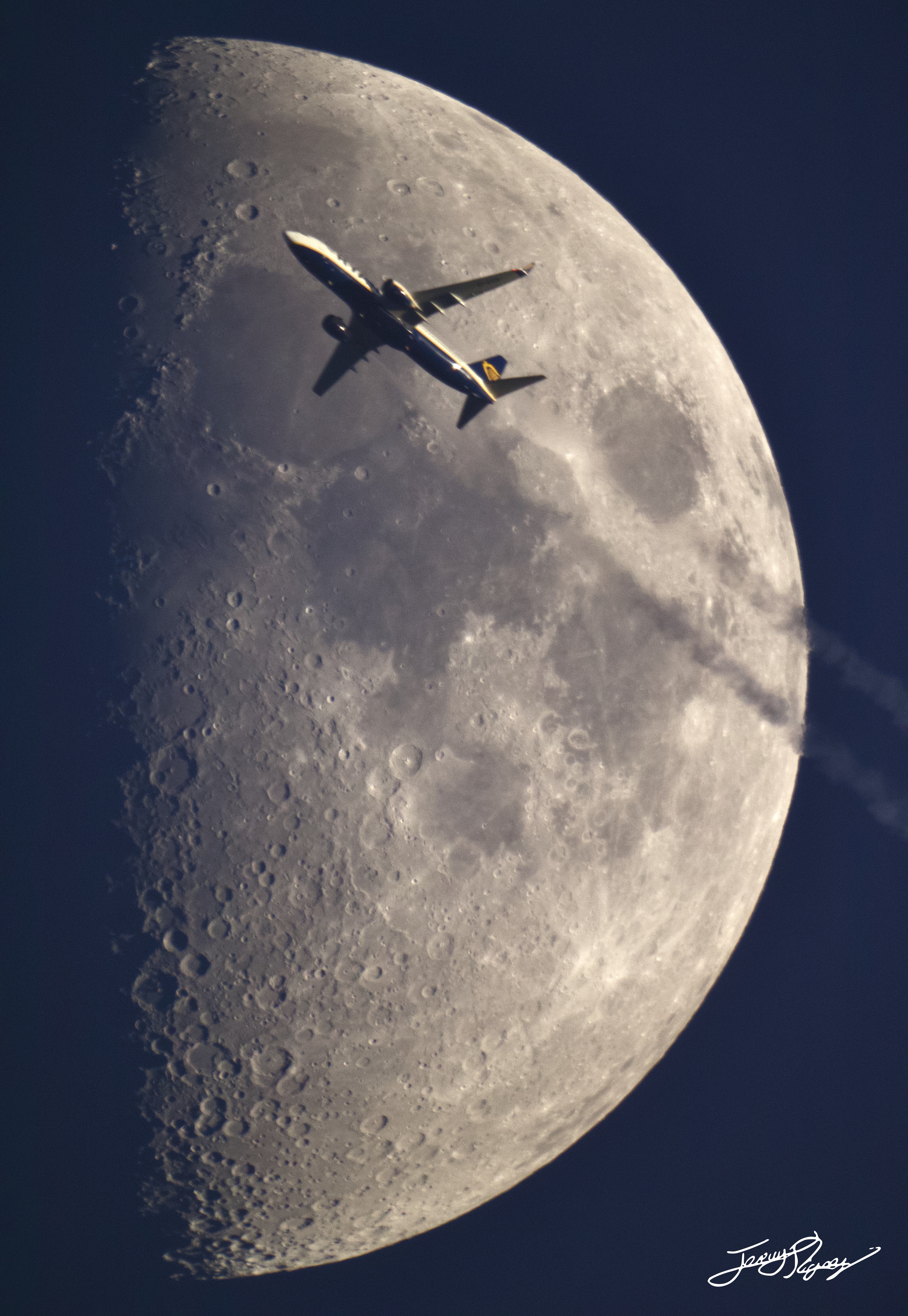 Ryanair Flight FR2970 from Tenerife to Edinburgh passing in front of a 50% illuminated moon. Ryanair Flight FR2970 from Tenerife to Edinburgh passing in front of a 50% illuminated moon.